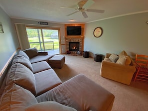 Living Room with gas fireplace, TV and walkout slider