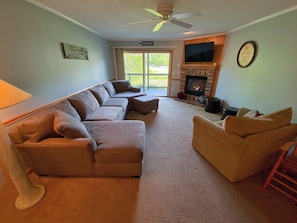 Living Room with gas fireplace, TV and walkout slider