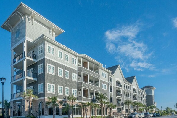 An expansive building with multiple balconies overlooking a central leisure area.