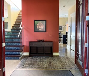 The foyer. Find more bedrooms, bathrooms, and the sun room with deck upstairs.