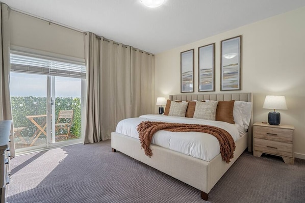One of the two primary bedrooms. Each offers a king sized bed, 58' smart TV, en suite bathroom and more.