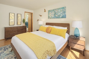 The master bedroom offers a queen bed and direct access to the master bathroom.