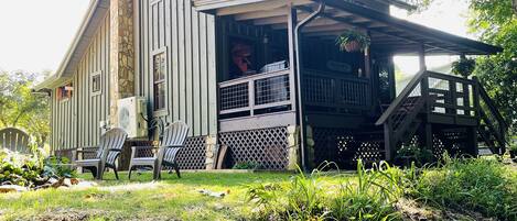 Side view of the cabin and  fire pit from the riverbank