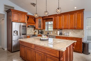 At the top of the stairs, you arrive at the incredible custom kitchen. 