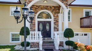 The columned covered porch welcomes you into the home, in style. 