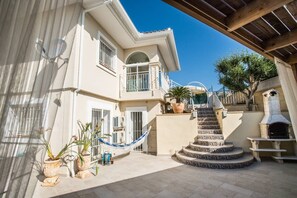 Stairs between the top and bottom of the terrace with a wonderful hammock to the left of the stairs