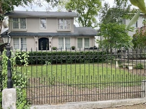 Fenced in front yard, with porch and lots of sitting area - great for yard games