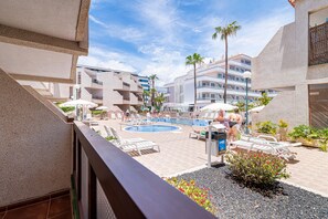 A pleasant balcony with a pool view.