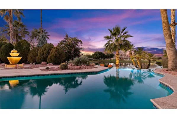 Infinity Edge Heated Pool Facing the Lake and Park alongside Lighted Fountain