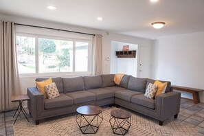 Enjoy the bright, open living room with couch seating plus chair and ottoman