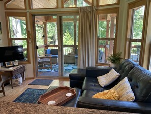 Blurring the lines between indoor & outdoor with a covered deck & living room. 