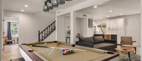 Large open concept Living area with pool/ping pong/dining table