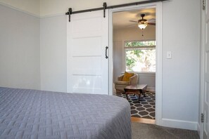 King bedroom with barn-doors that separate the bedroom and living room