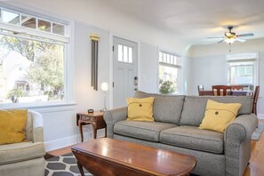 Cozy living and dining rooms with ample natural light.  The couch folds into a bed for added sleeping space.