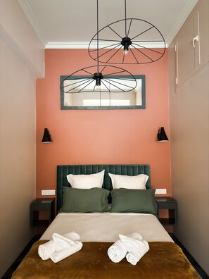 A closer look at the bed, featuring plush bedding and thoughtful touches for a restful retreat.