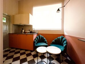Bright and airy dining corner with elegant chairs, offering a great spot to enjoy coffee while basking in natural light.