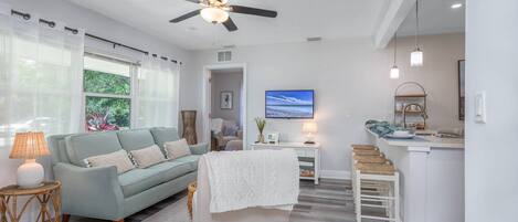 Living room furnishings in soft beach themed colors with warm accents.  Enjoy streaming your favorite apps on the Smart TV.