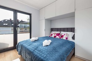 The cosy bedroom features a luxurious double bed and ample storage.
