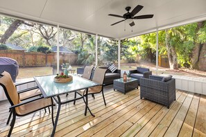 Newly constructed screened-in back patio  with fan, outdoor dining and lounge