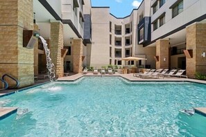 Enjoy a refreshing dip in the sparkling pool with sun loungers.