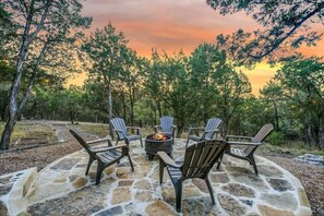 Outdoor firepit and seating area, picnic table, and a gas grill