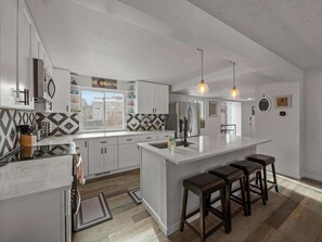 This fully remodeled kitchen has new appliances (oven range, refrigerator, dishwasher, microwave), all the utensils, pots and pans needed for cooking for that crew!