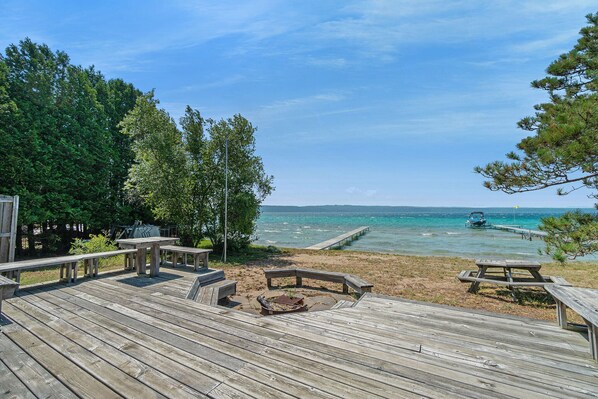 Private beach deck with fire pit and dock on Crystal Lake