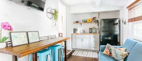 Cozy living space with kitchenette and work table