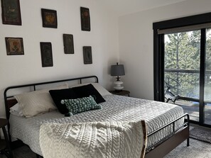 Upstairs bedroom with 43" Smart TV attached to deck