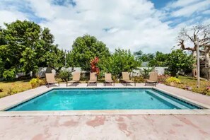 POOL WITH LOUNGE CHAIRS.