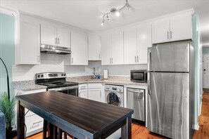 Washer/dryer combo located in kitchen