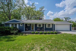 Welcoming front porch and peaceful yard at this centrally located ranch home.