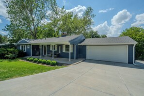 Charming ranch home with private driveway, two-car garage, and covered entry.