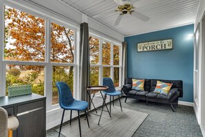 Coffee sitting area in the porch and couch that folds down to make a futon bed.