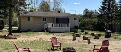 The large backyard includes a fire pit, horse shoe pit and outdoor games