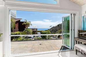 Large folding doors to open the living room to the ocean view side patio