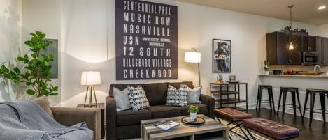 Living room with smart TV and designer furnishings.