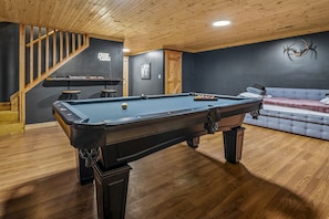 Basement Game room has pool table, bar top, ping pong, and trundle bed.