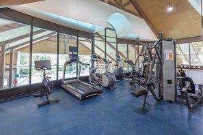 Fully equipped fitness center overlooking the pool.








