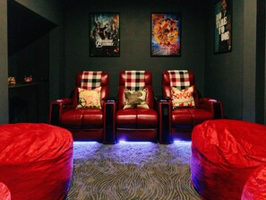 Movie Room with 3 reclinable movie theatre-quality seats, lighted cup holders, and trays to hold your food/popcorn