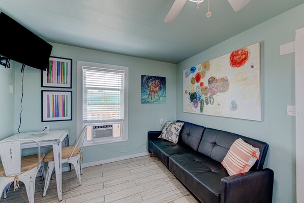 Living room and dining room - Colorful splashes adorn this combo dining/living space with a futon
