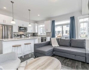 Cozy living room with HD TV perfect for watching movies by the fire.