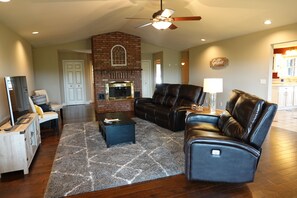 The living room connects to the kitchen and has board games under the TV.