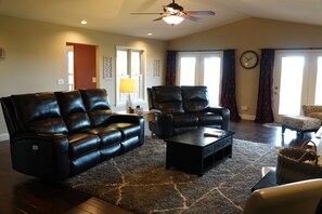 The back deck is accessed off the living room, and the leather couches recline.