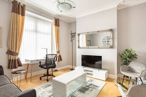 Living room with work area and large TV