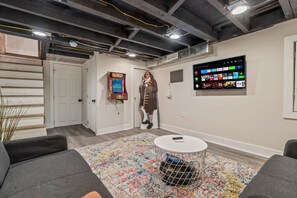 You will appreciate the charm of this cozy basement lounge with its inviting decor and comfy seating. Perfect for relaxing after a day of exploring the city.