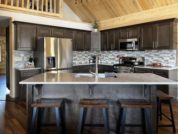 Kitchen with large island and seating for 4.