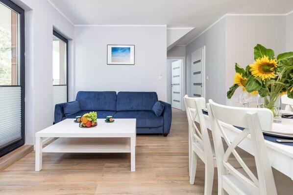 The elegant living room featuring a double sofa bed.