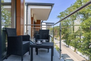 Step out onto the balcony directly from the bright living room. 