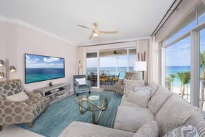 Living area with large television and board games. 